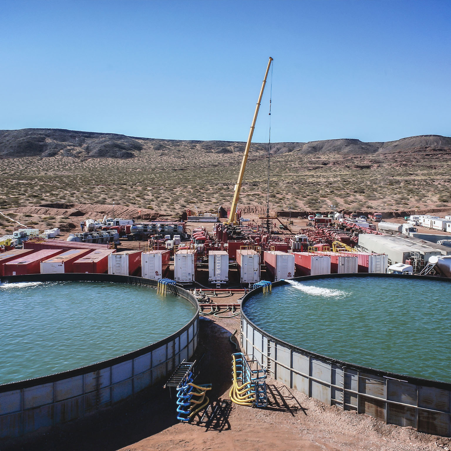 Vaca Muerta, Argentina, August 26, 2014: Extraction of unconventional oil. Battery of pumping trucks for hydraulic fracturing (Fracking).