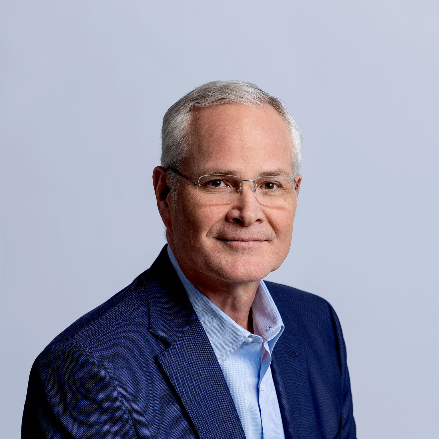 A headshot of Darren Woods smiling softly.