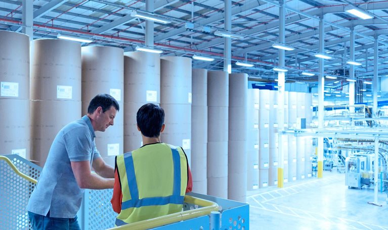 Two men inside a paper factory
