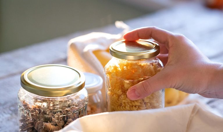 Woman standing indoors, unpacking zero waste shopping