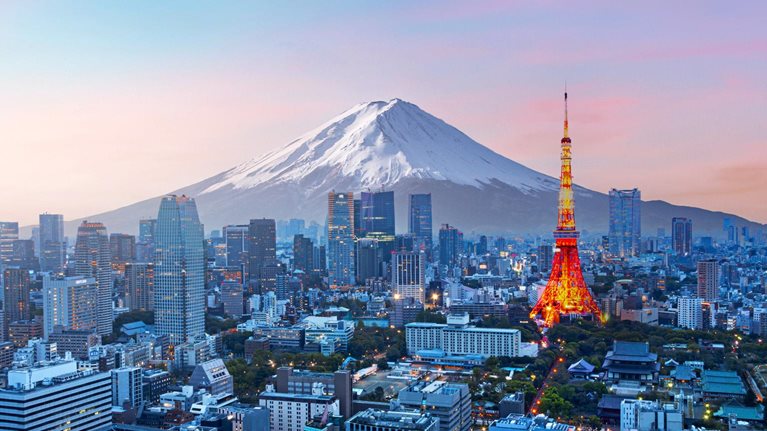 Mt. Fuji and Tokyo skyline at dusk.