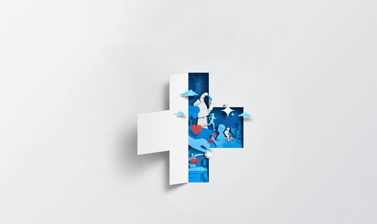 A white sheet of paper has been cut and folded in half, creating the silhouette of a medical cross. The empty space left by the folded paper is filled with blue and red shapes that show health and well-being. Some shapes include exercise, family activities, and medical care.