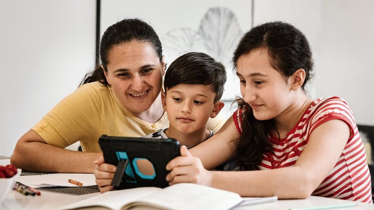 Woman and children looking at tablet