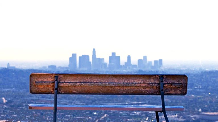 Empty bench facing the city