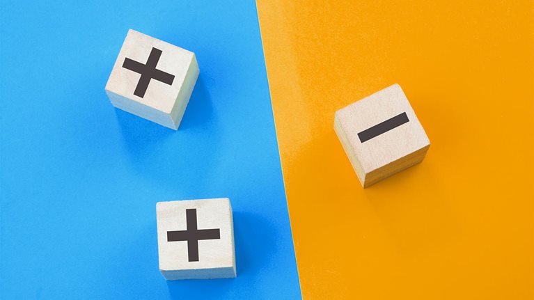 Image of 3d cubes with plus and minus signs on different sides of a colored background.