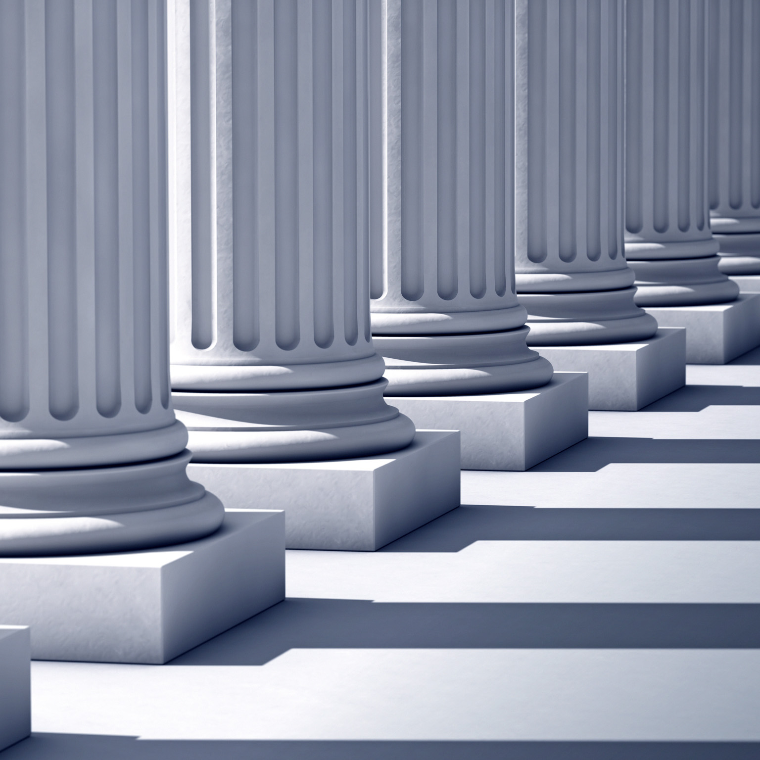 A deep row of stone columns casting long, linear shadows.