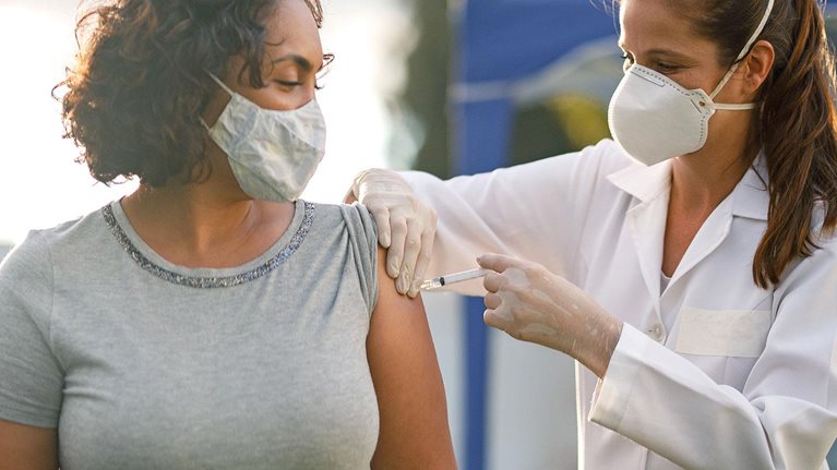 A patient receiving an injection from a nurse