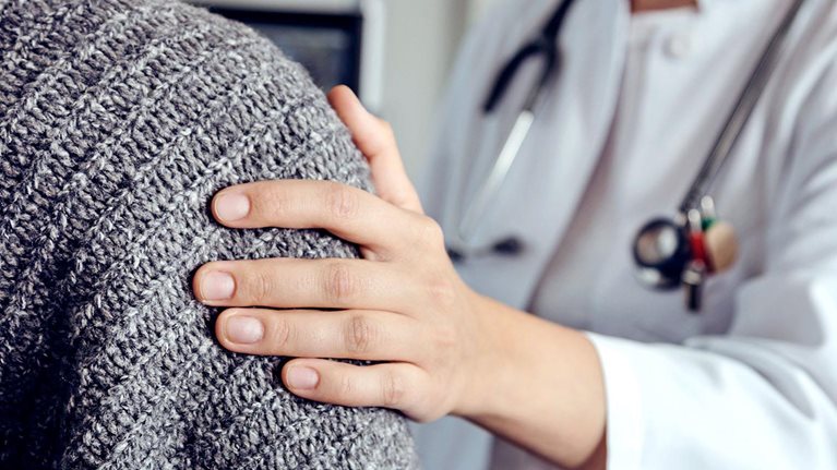 Doctor soothing senior patient