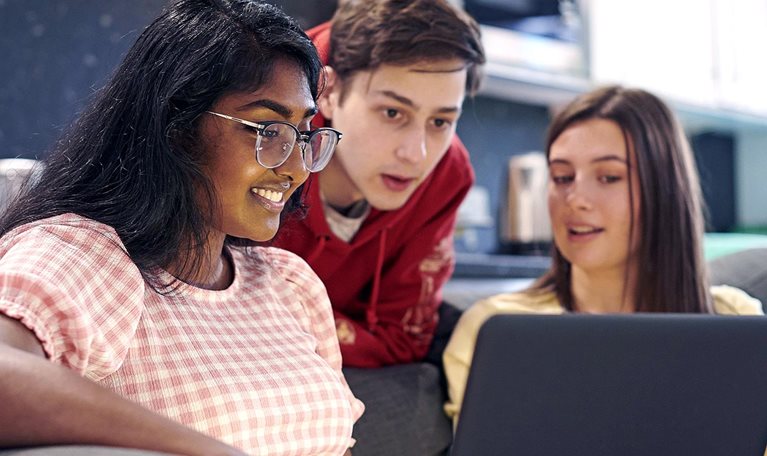 Friends hanging out together and chatting in university housing.