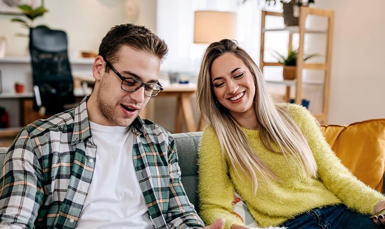 Modern couple with their pet dog at home