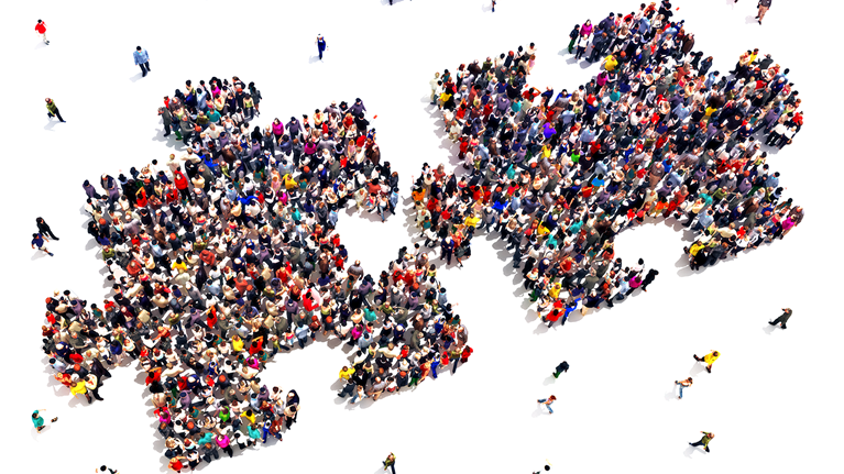 Jigsaw puzzle pieces joining to grow