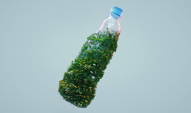 Digital generated image of grass and flowers growing on used plastic bottle against gray background.