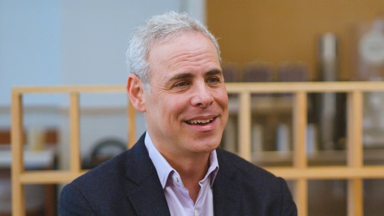 Image of Brett Schulman smiling during an interview.