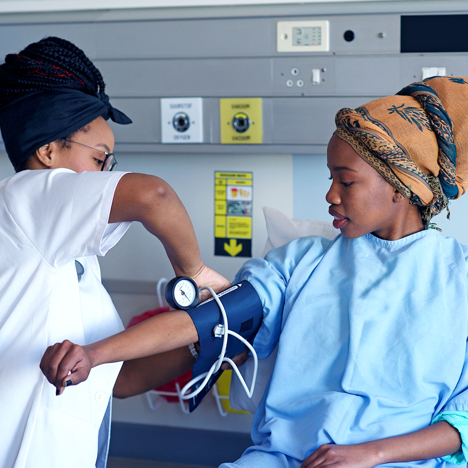 An African doctor taking a patient's blood pressure