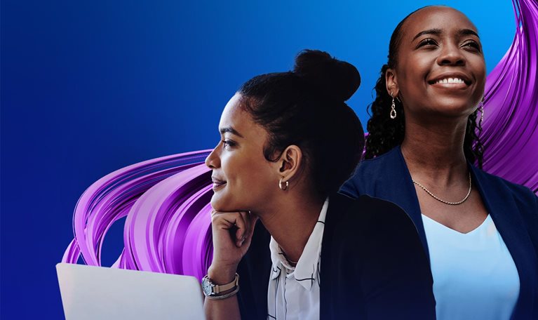 Two women working together on a laptop.