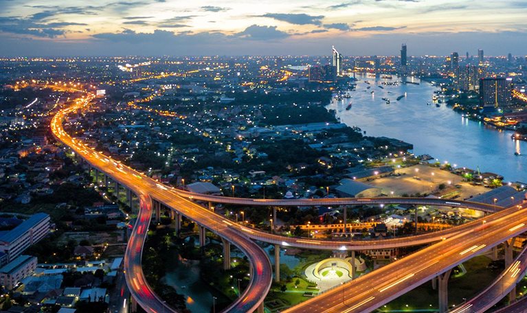 Aerial view of Bhumibol suspension bridge cross over Chao Phraya River in Bangkok city with car on the bridge at sunset sky and clouds in Bangkok Thailand. - stock photo