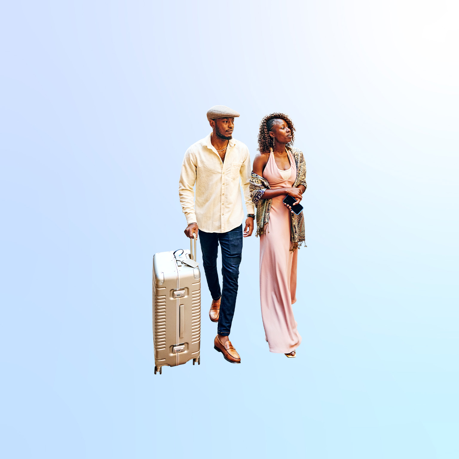 Wide shot of couple arriving in hotel courtyard with rolling luggage while on vacation