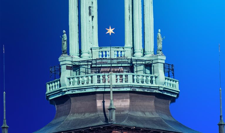 Stockholm City Hall on the eastern tip of Kungsholmen island, facing the islands of Riddarholmen and Södermalm, in Stockholm, Sweden. Its 106-metre tower is topped with the Three Crowns, the Swedish national symbol.