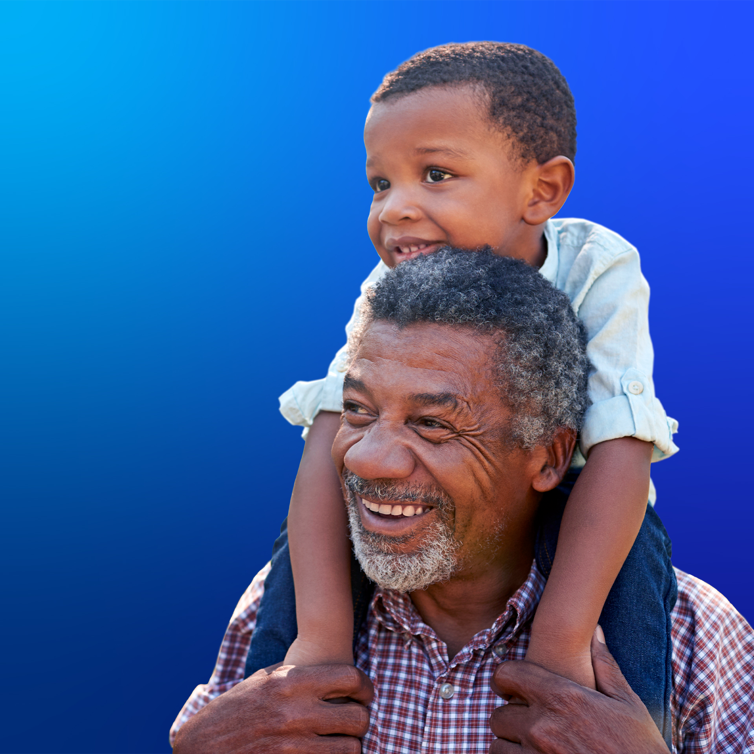 Grandfather carries grandson on shoulders during walk in park
