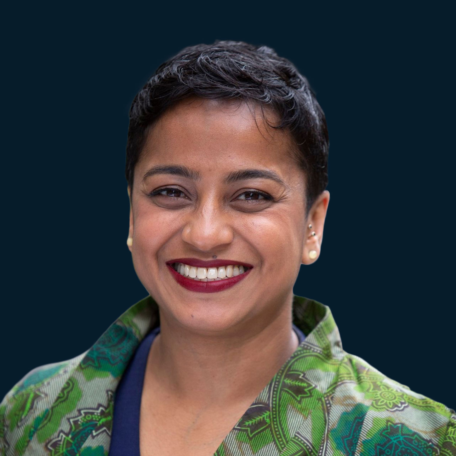 Mental health advocate Poppy Jaman smiles towards the camera.