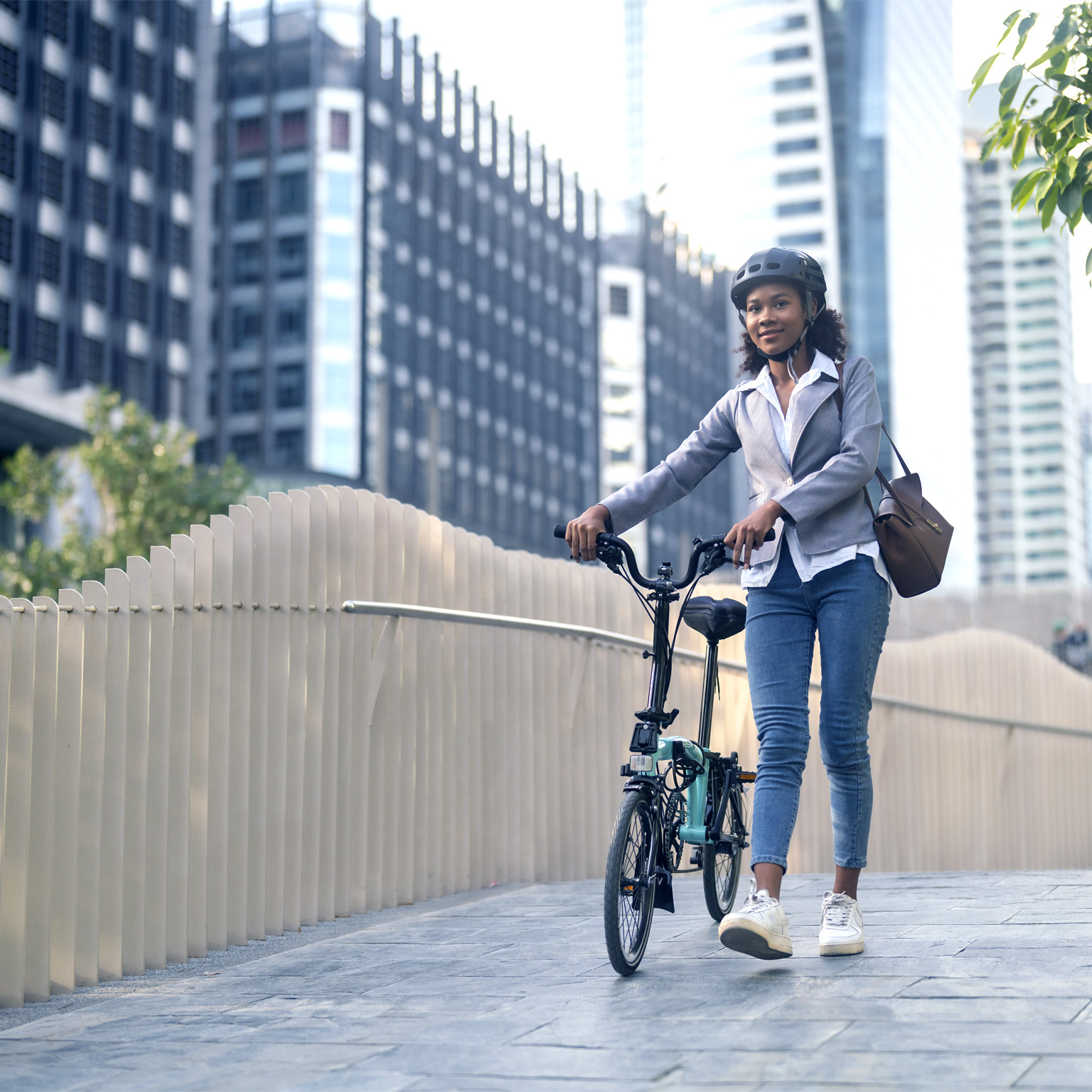 Image of a woman cycling to work in a city.