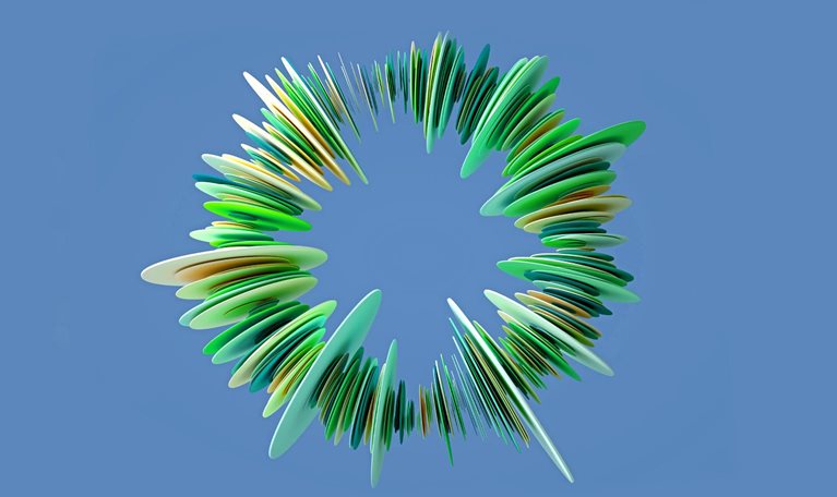 An abstract ring-like structure composed of many green, yellow, and blue layered, petal-shaped elements. It has a sense of depth and is set against a solid blue background.