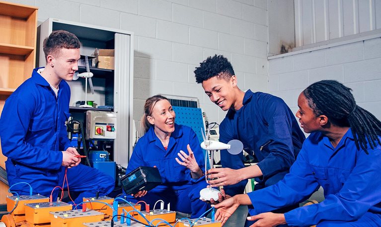 Four high schoolers work on an engineering project together